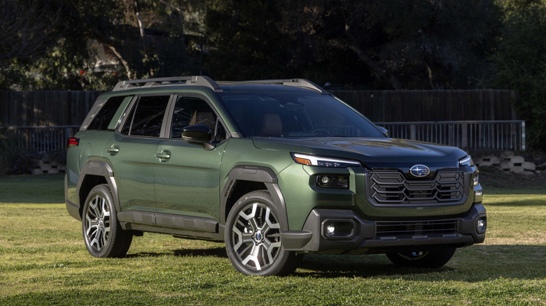 front three quarters of the new Subaru Outback in green parked on a lawn