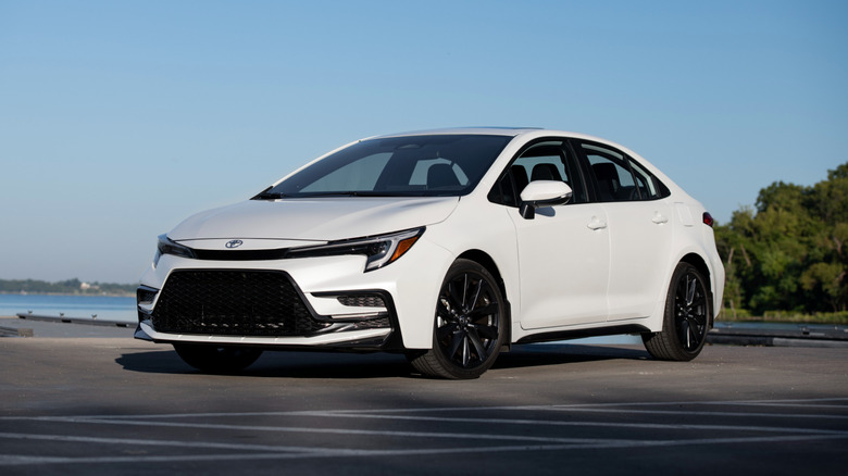 A pearl white 2025 Toyota Corolla in a parking lot