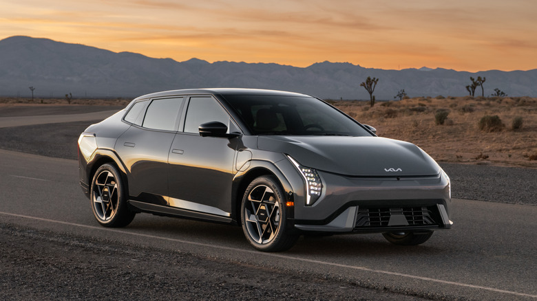 gray EV4 sedan parked in front of joshua trees in the desert